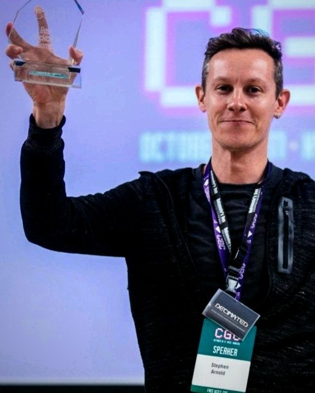 Stephen, founder of OpexStream, holding an industry award on stage